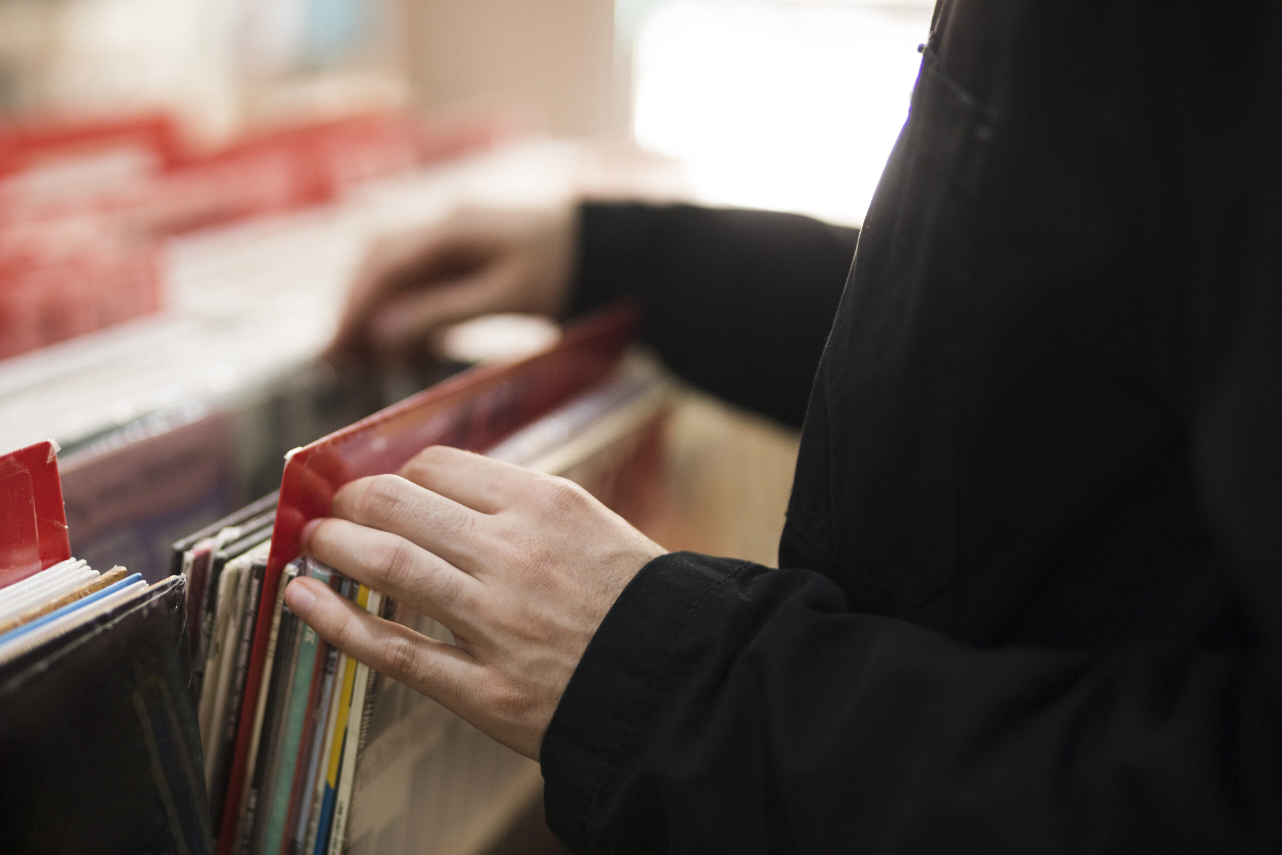 close-up-young-man-looking-vinyls-store